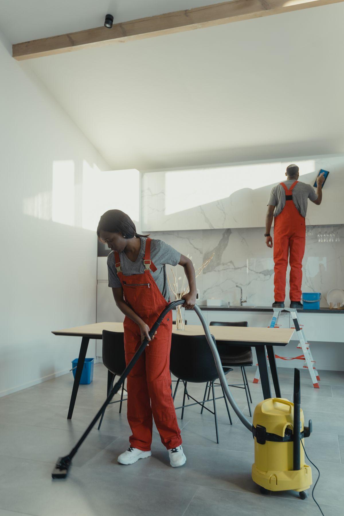 Cleaners working in a bright residential kitchen
