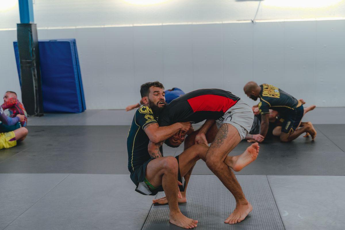 Martial artists training on sports mats
